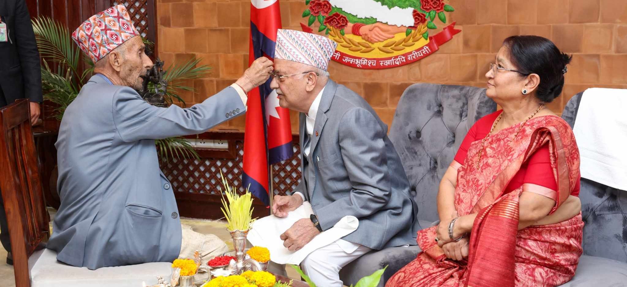 PM Oli receives Tika from his father