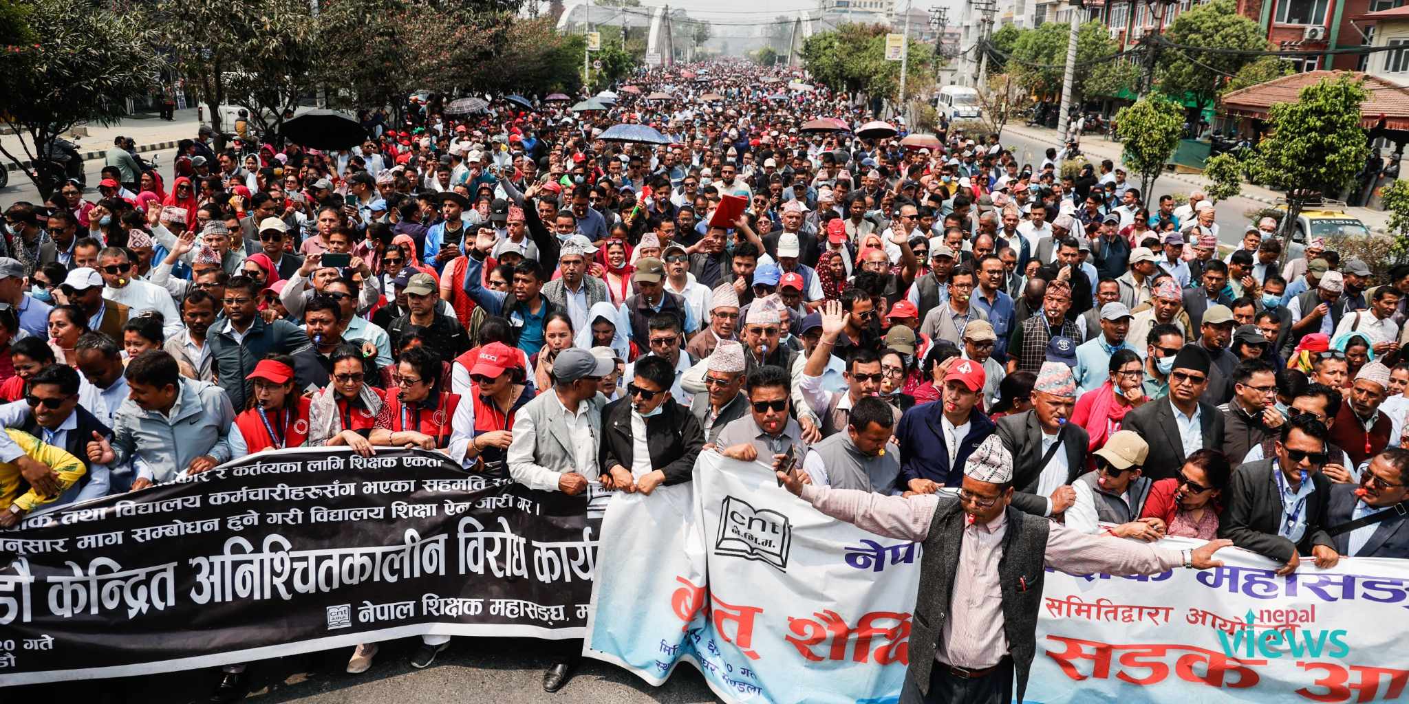 Teachers demonstrate by blowing whistles (Photo Feature)